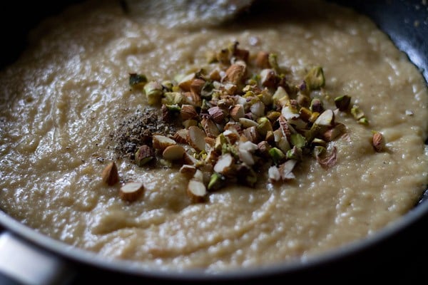 chopped nuts and cardamom powder added to the sweetened khoya mixture. 