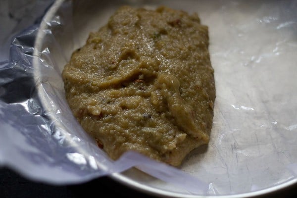 cooked burfi mixture transferred in the prepared tray. 