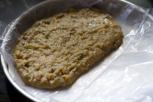 cooked khoya mixture spread evenly in the prepared tray. 