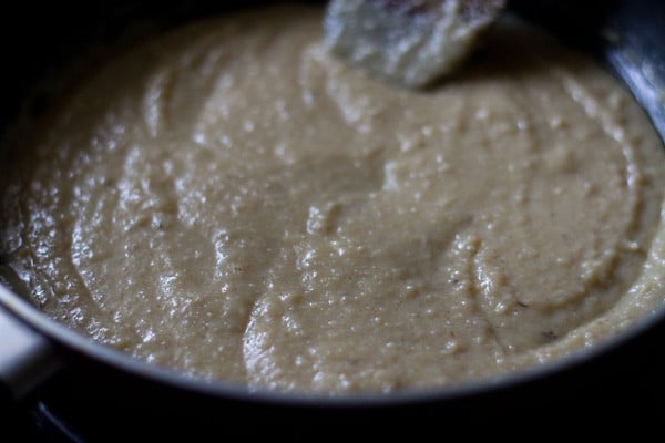 cooking the sweetened khoya as it turns slightly thin. 