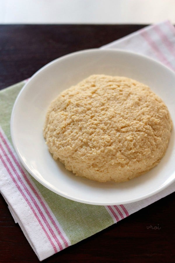 khoya or mawa shaped in a disk and placed on a white plate.