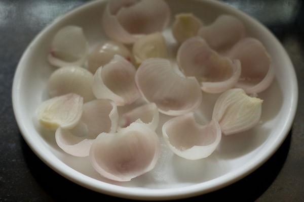 blanched onion halves on a white plate