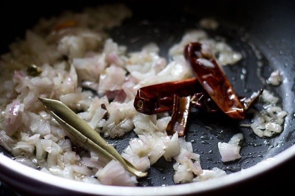 onions being sautéed with the spices