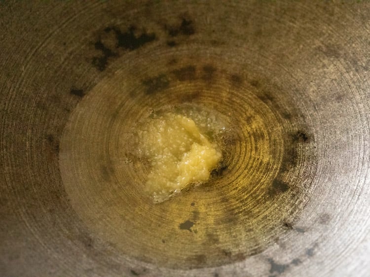 heating ghee in a heavy pan for making suji ke laddu. 