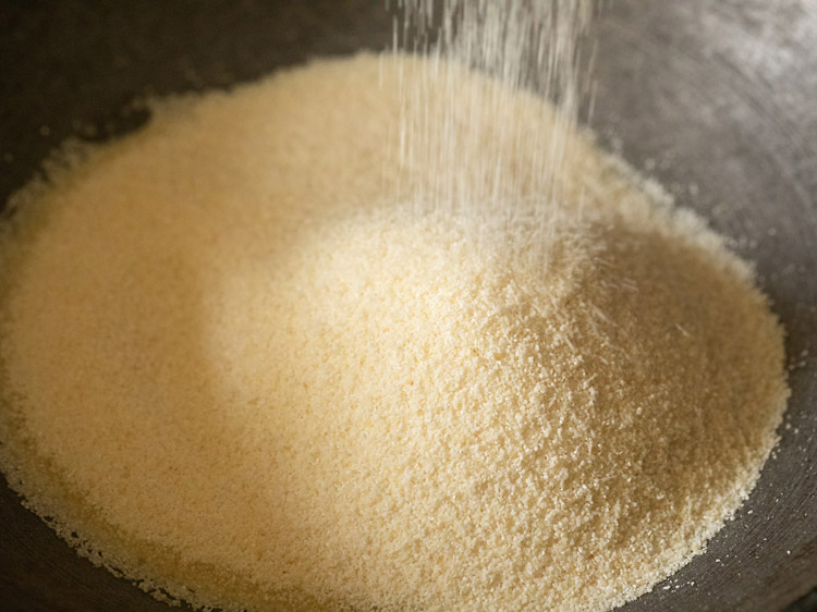 adding rava in the hot ghee for making suji ke laddu. 