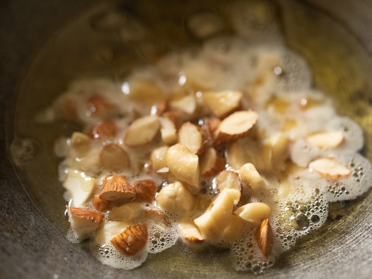 chopped mixed nuts added to the hot ghee in pan. 