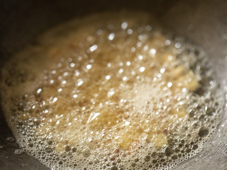 frying nuts in the hot ghee. 