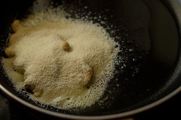 adding rava or suji in pan.