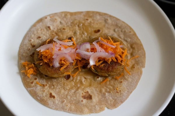 roti, tikkis, grated carrots and sliced onions