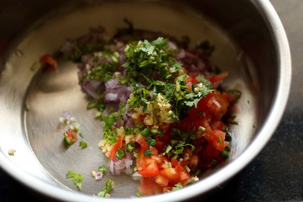 finely chopped ingredients added to bowl for making batter for besan toast. 