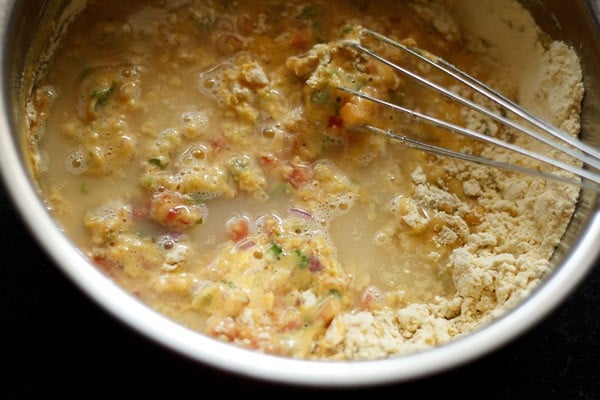 water added to the bowl and mixed with a whisk for making batter for besan toast. 