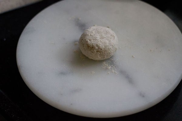 some flour sprinkled over dough ball. 