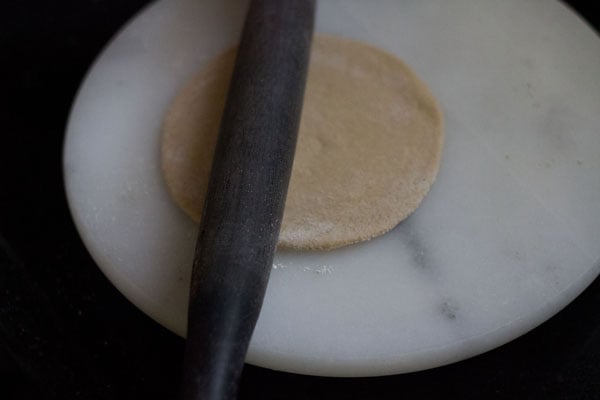 rolling dough ball in disc with medium thickness. 