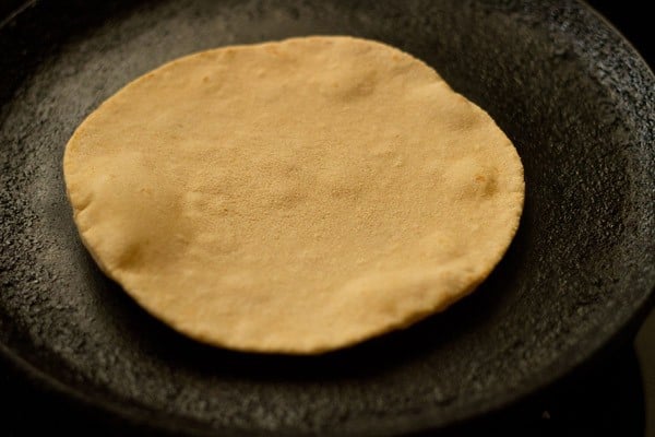 cooking butter naan on hot tawa. 