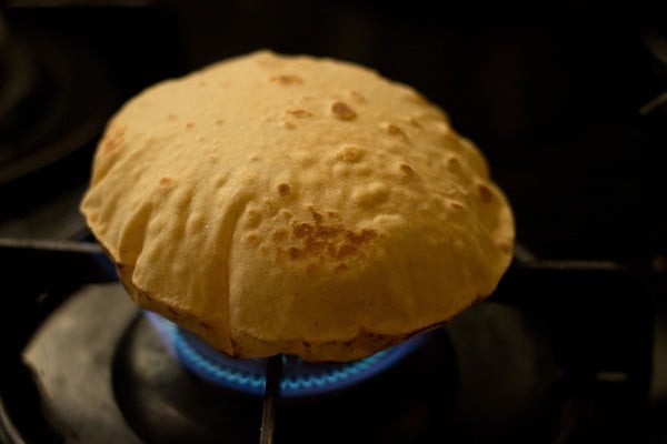 puffing up the butter naan on direct flame. 