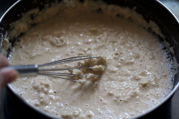 whisking the mixture in the bowl. 