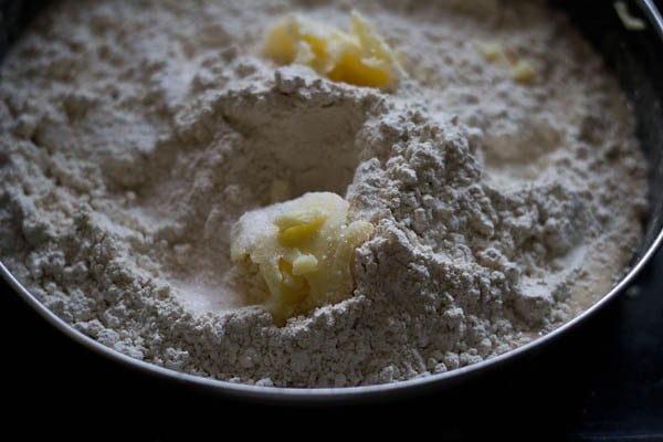 remaining whole wheat flour, softened butter, curd and salt added to the mixture for butter naan recipe. 