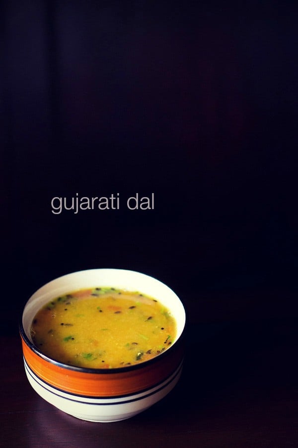 Gujarati dal in a black rimmed ceramic bowl on a black background