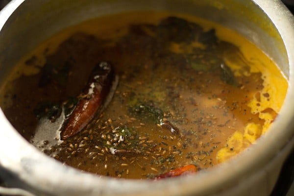 tempering mixture floating on top of the dal 