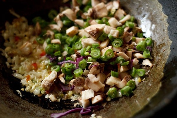 add mushrooms - making veg manchow soup recipe