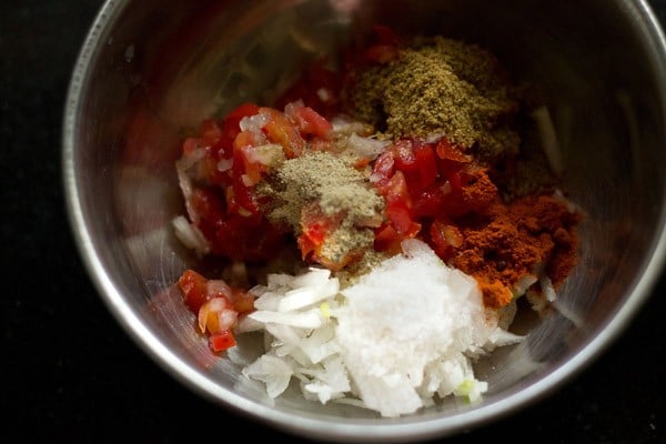 ingredients for masala topping added in a bowl for masala papad. 