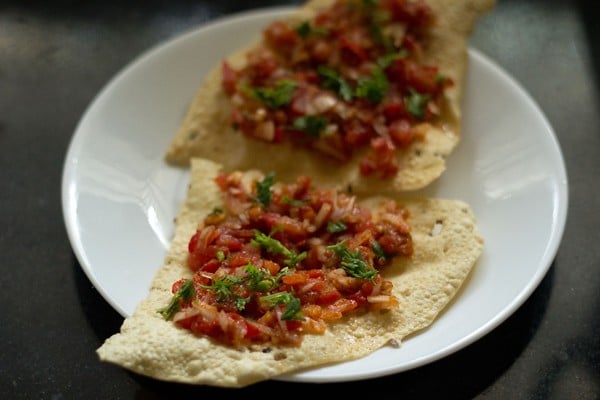 chopped coriander leaves added on top of masala papad. 