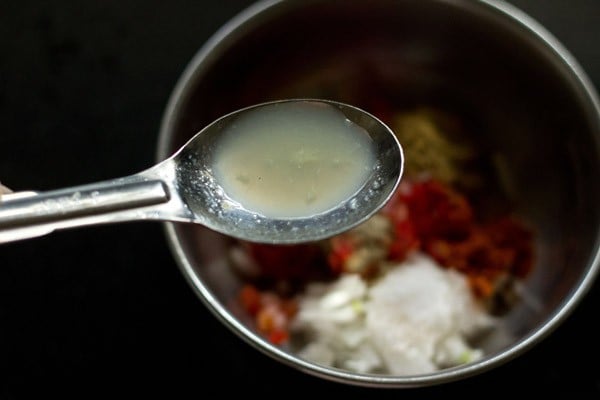 adding lemon juice to the masala topping. 