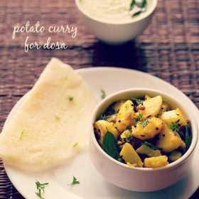 potato masala served in a bowl with a dosa and a bowl of coconut chutney kept on the top side and text layovers.