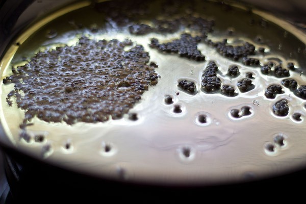 frying cumin seeds in hot oil. 