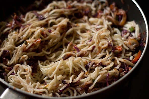 stir vegetables and chow mein noodles together