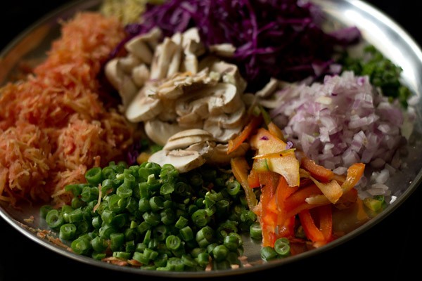 chopped veggies on a silver plate waiting to stir fry