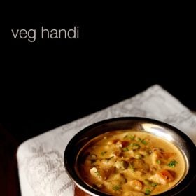 veg handi garnished with coriander leaves and served in a copper handi with text layover.