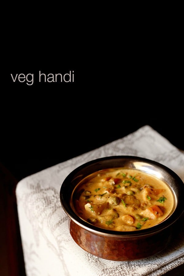 veg handi garnished with coriander leaves and served in a copper handi with text layover.