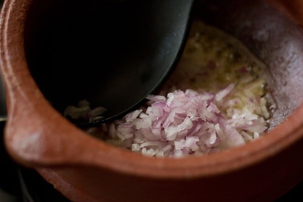 adding chopped onions for veg handi recipe