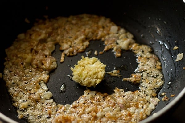 adding ginger-garlic paste to onions 