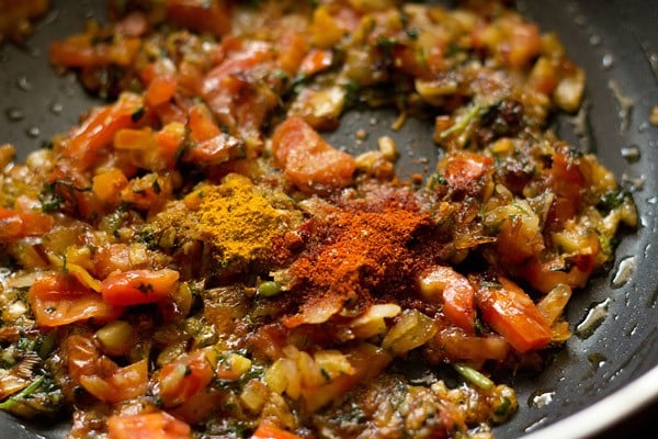 adding turmeric powder, red chili powder and asafoetida to onion mixture 