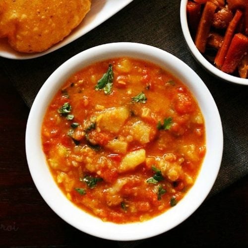 top shot of aloo rasedar served in a white bowl.