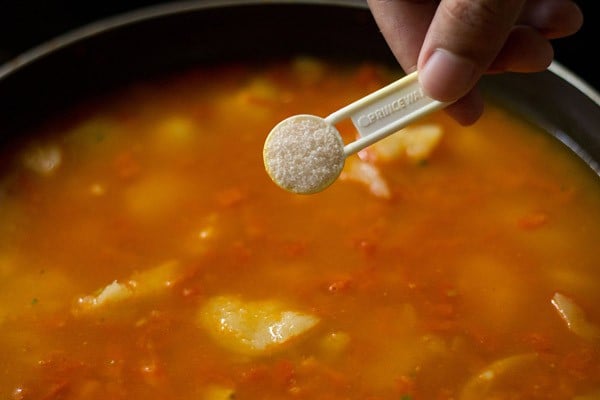 adding salt to the pan. 