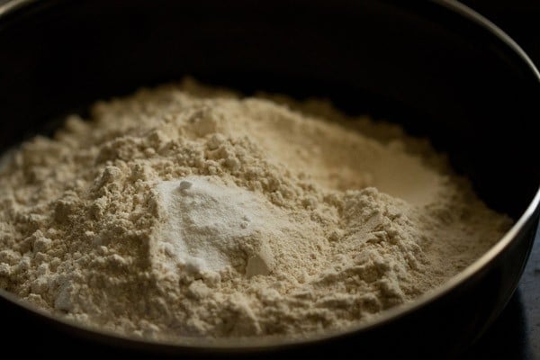 flour and baking soda in a black mixing bowl