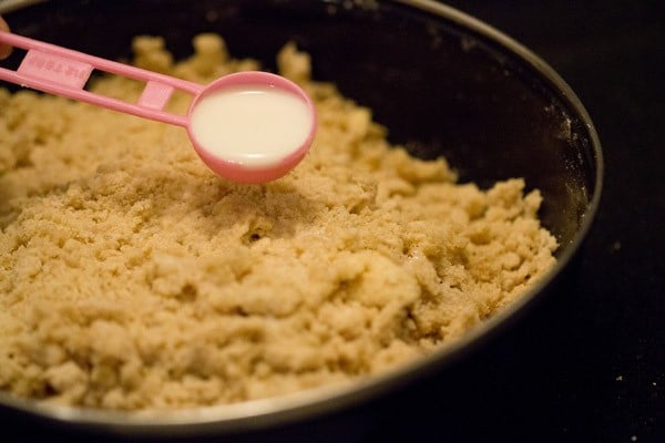 adding milk to the dough