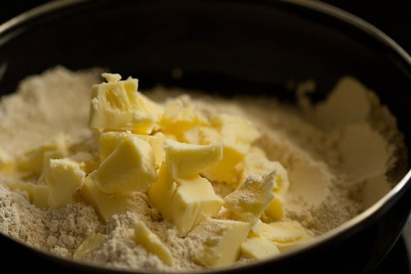 cold butter cubes on flour mixture