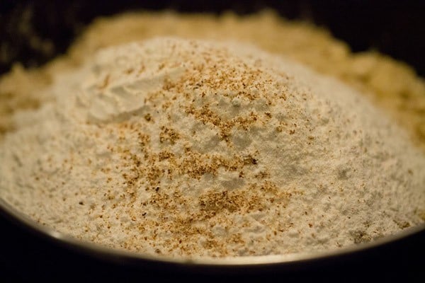 adding grated nutmeg and powdered sugar to the flour blend