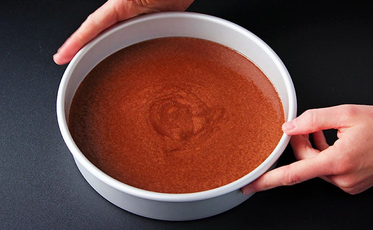 tapping the sides and edges of the pan to release air bubbles from the batter