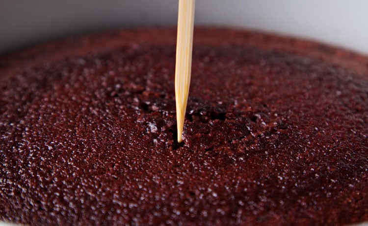 testing healthy eggless chocolate cake with bamboo skewer