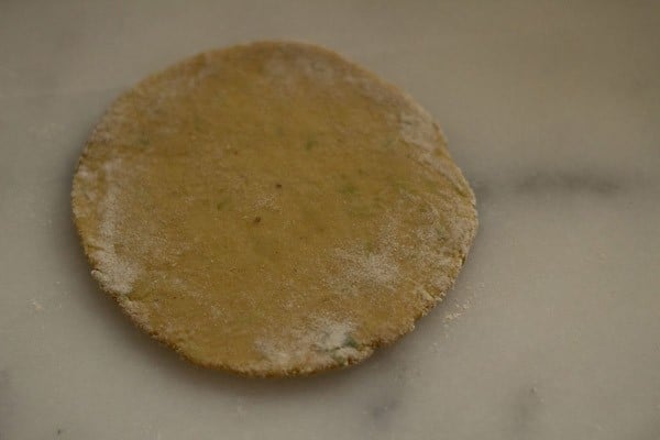 rolling dough with a light sprinkle of flour for dudhi na thepla.