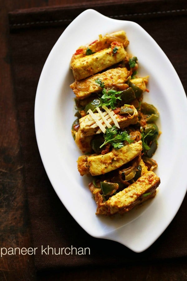 paneer khurchan garnished with coriander leaves, ginger juliennes and served on a white plate.