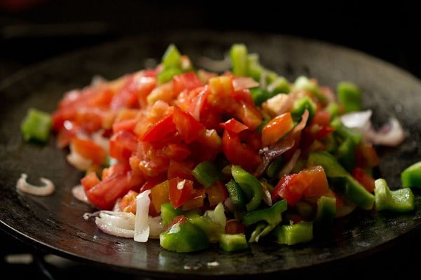 chopped capsicum and tomatoes added