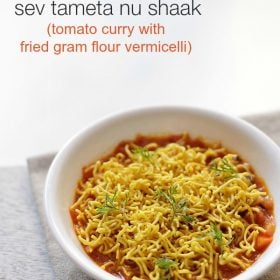 sev tamatar ki sabji garnished with sev and coriander leaves and served in a white bowl with text layovers.