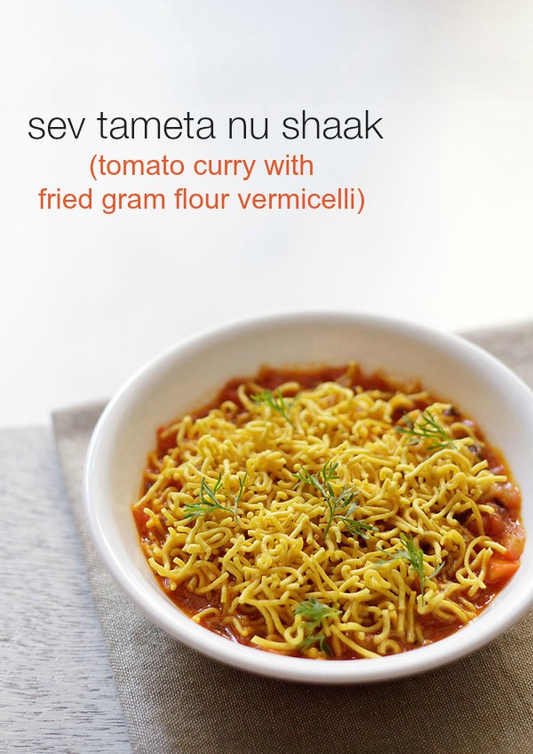 sev tameta nu shaak garnished with sev and coriander leaves and served in a white bowl with text layovers.