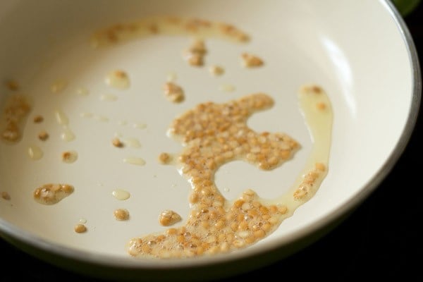 frying urad dal in the pan. 